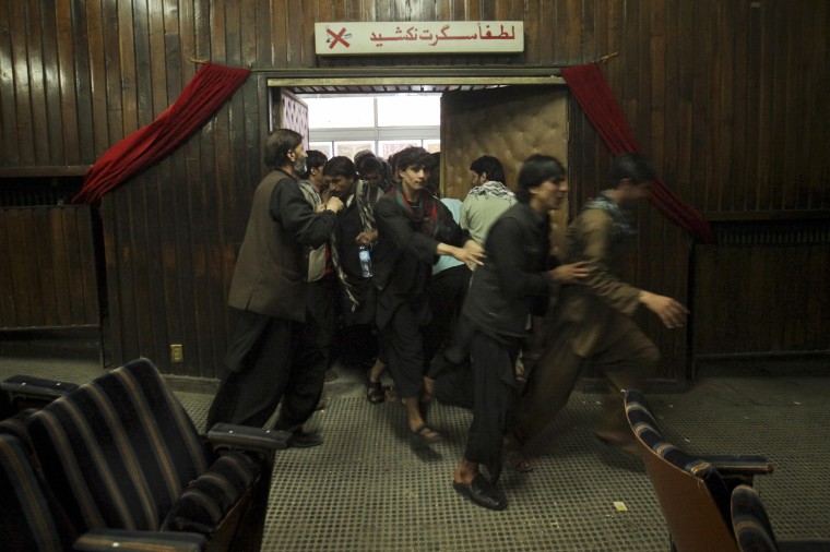 Cinema goers rush into the theater before a show at Pamir Cinema in Kabul on May 4.