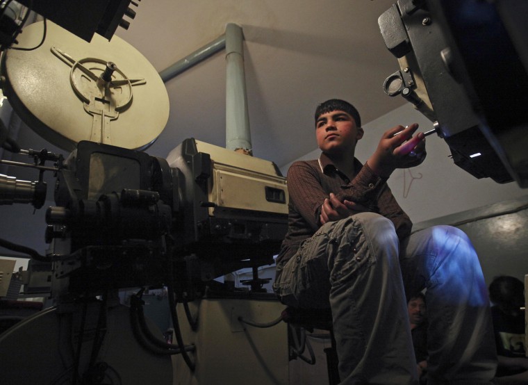 Ahmad Wali, a 15-year-old projectionist, works inside the projection room at Pamir Cinema in Kabul on May 2.