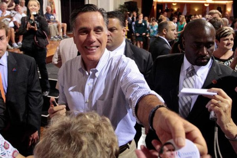Republican presidential candidate Mitt Romney handing out an autographed button after speaking at a campaign stop in Florida on Thursday.