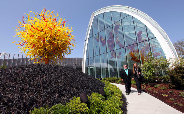 Dale, left, and Leslie Chihuly walk into the garden area and past the Glasshouse during a preview of the Chihuly Garden and Glass exhibit.