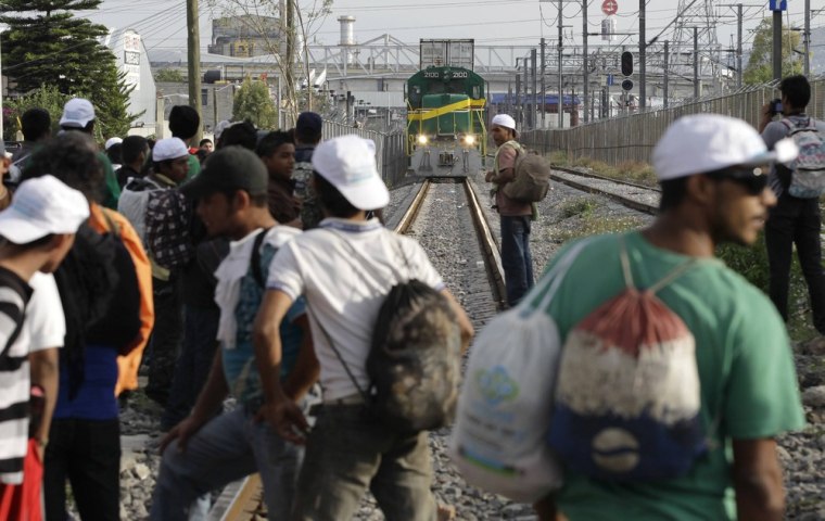 Migrants from Central America wait for a freight train after taking part in a protest in Lecheria, in Tultitlan, Mexico on May 17, 2012.