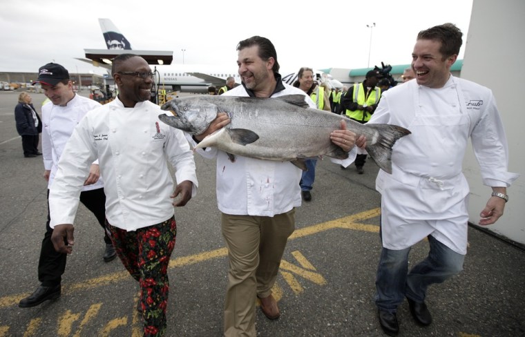 Executive chef Pat Donahue, of Anthony's Restaurants, executive chef Wayne Johnson, of Ray's Boathouse, Frankie Ragusa, general manger of Ocean Beauty Seafoods, and executive chef Jason Wilson, of Crush, walk with a 55 lb. Copper River King Salmon on May 18.