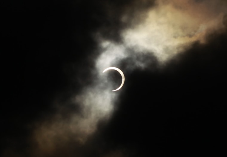An annular solar eclipse is seen briefly during a break in clouds over Taipei, Taiwan.