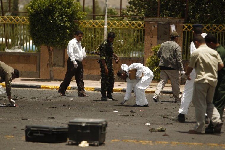Police collect evidence after a suicide bombing at a parade ground in Sanaa, Yemen, on Monday.