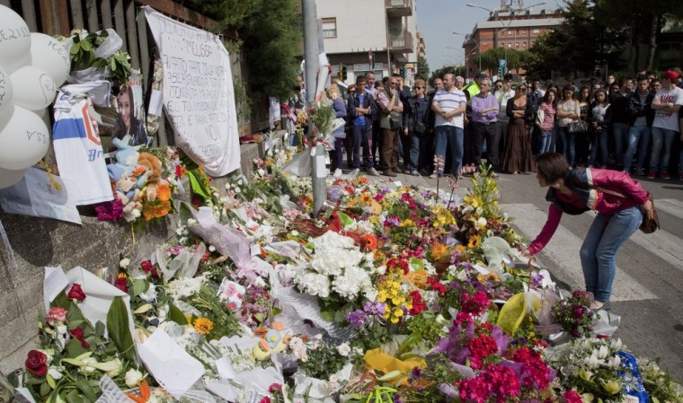 Flowers are displayed outside the Francesca Laura Morvillo Falcone school on May 21 in Brindisi, ahead of Melissa Bassi's funeral. Italian police have arrested two suspects over the bombing of a school that killed the 16-year-old girl and seriously injured five more teenagers.