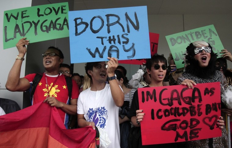 Filipino fans of pop star Lady Gaga hold slogans outside the concert venue before her performance in suburban Pasay, south of Manila, Philippines, May 21. Authorities in the conservative, majority Roman Catholic country approved the concerts, set for May 21, and Tuesday, but said they won't allow nudity or lewd acts. A religious group warned they will sue Lady Gaga and concert organizers if she sings