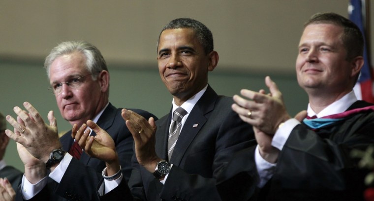 President Barack Obama, center, with Missouri Gov. Jay Nixon, left, and Superintendent C.J. Huff, right, applaud the Class of 2012 Monday night.