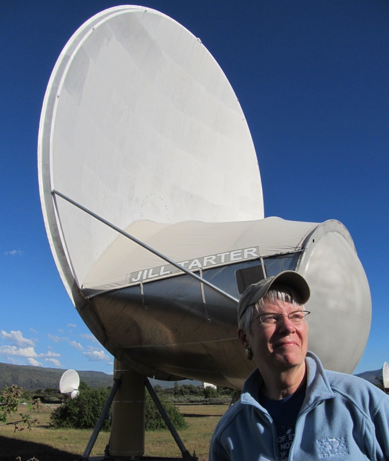 SETI astronomer Jill Tarter looks out from the radio dish named after her at the Allen Telescope Array in northern California. The array's 42 linked dishes search for signals from extraterrestrial civilization - and also keep track of Earth-orbiting satellites.