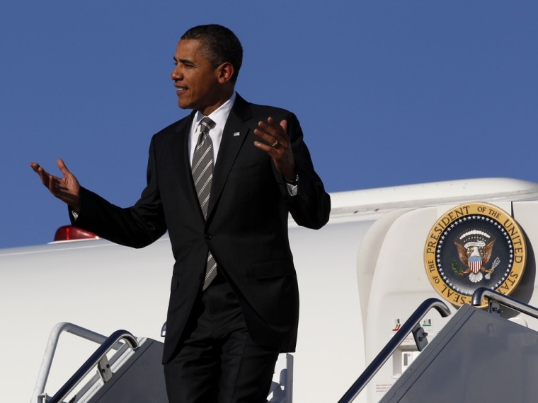 President Barack Obama gestures upon arriving at Joplin Regional Airport aboard Air Force One in Missouri.
