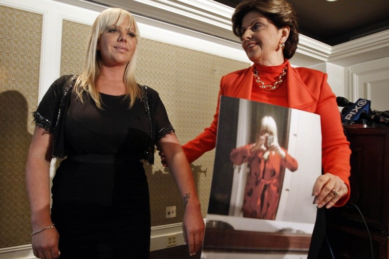 Lauren Odes and her attorney Gloria Allred (R) speak at a news conference in New York, May 21, 2012.  Odes is suing her former employer, caliming she was dismissed for dressing too provocatively.