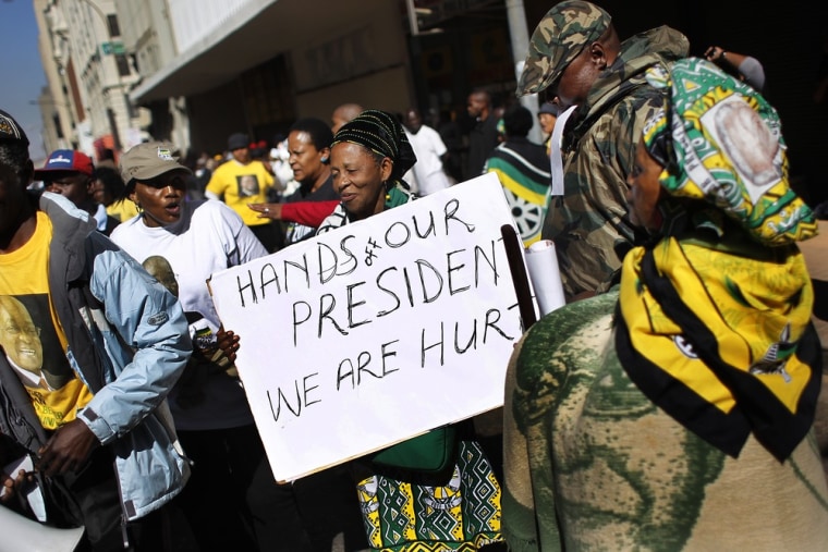 Amid the controversy, supporters of South African President Jacob Zuma gather outside the South Gauteng High Court in Johannesburg on Tuesday.