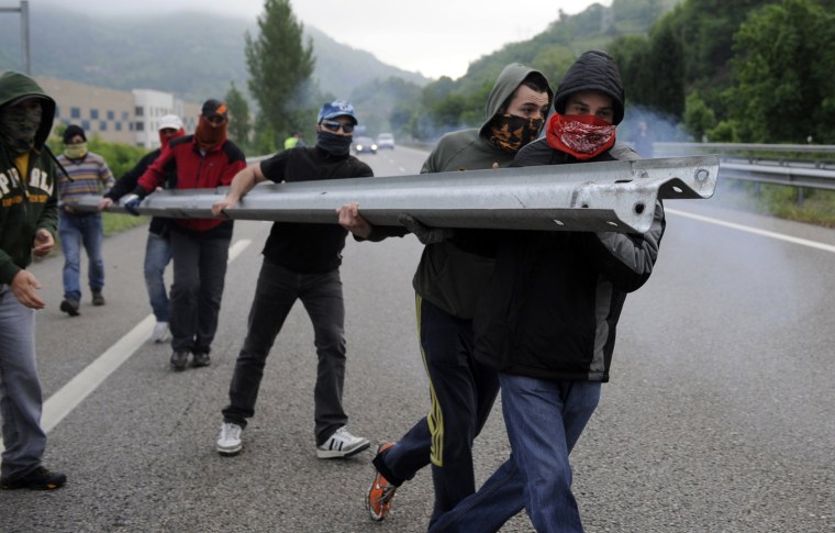 Miners on strike move to set up a barricade on the A-66 motorway, on the first day of a strike to protest the government's spending cuts in the mining sector, in Pola de Lena, near Oviedo, northern Spain, May 23. Spain's economy is contracting for the second time since late 2009 and four years of stagnation and recession have pushed unemployment above 24 percent, the highest rate in the European Union.