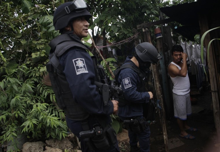 Police officers talk to a man during a routine patrol of a neighborhood in Guadalupe, Mexico, on April 13.