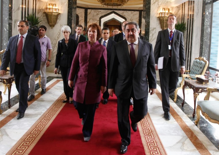 Iraq's Foreign Minister Hoshyar Zebari, second right, walks with the EU foreign policy chief Catherine Ashton upon her arrival at Baghdad International Airport on Wednesday for multi-party nuclear talks.