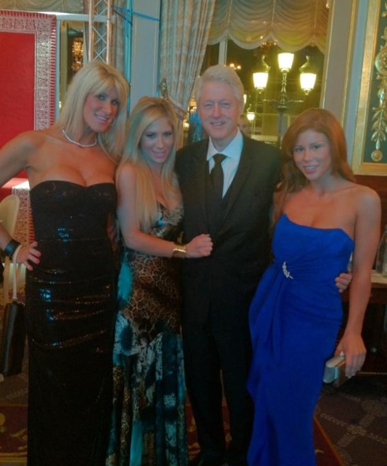 Former president Bill Clinton poses with adult film stars Tasha Reign, second from left, and Brooklyn Lee, right, in Monte Carlo, Monaco on Wednesday.