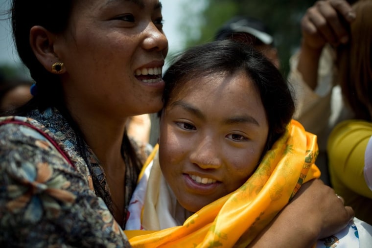 Nima Chemji Sherpa, 16, is welcomed by friends and family at Domestic airport in Kathmandu, Nepal, on May 25, 2012.