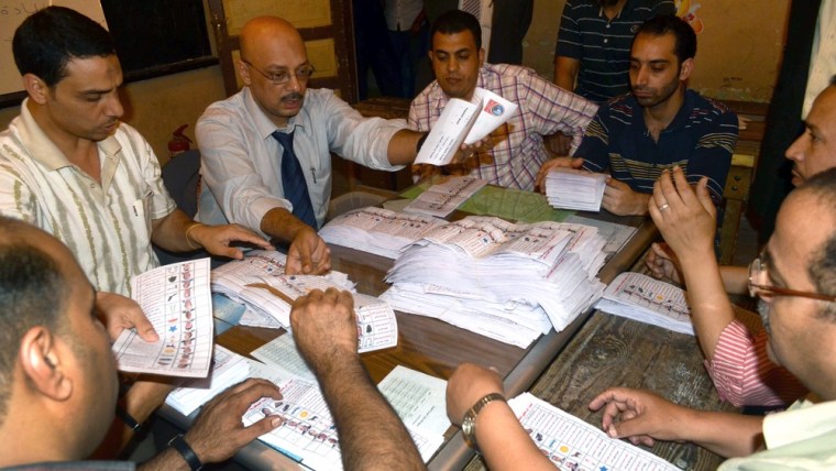 Egyptian election officials count ballot papers at a polling station in Alexandria after polls closed Thursday.