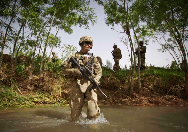 Michael Foley, U.S. Army Lieutenant of the Battle company, 1-508 Parachute Infantry battalion, 4th Brigade Combat Team, 82nd Airborne Division, crosses a canal during the joint Tor Janda (Black Flag in Pashtu) operation with Afghan security forces in Zahri district of Kandahar province, southern Afghanistan on May 25.