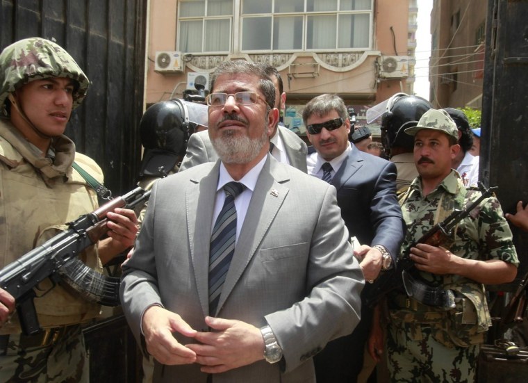 Presidential candidate Mohamed Mursi arrives at a polling station to cast his vote in Al-Sharqya northeast of Cairo on Wednesday.