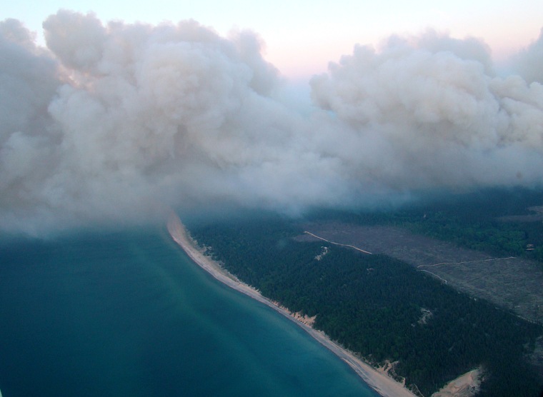 A wildfire in Michigan's Upper Peninsula grew by 17 percent to more than 21,000 acres, May 26, as officials warned of tough conditions and welcomed help from water-dumping aircraft from the Michigan National Guard.