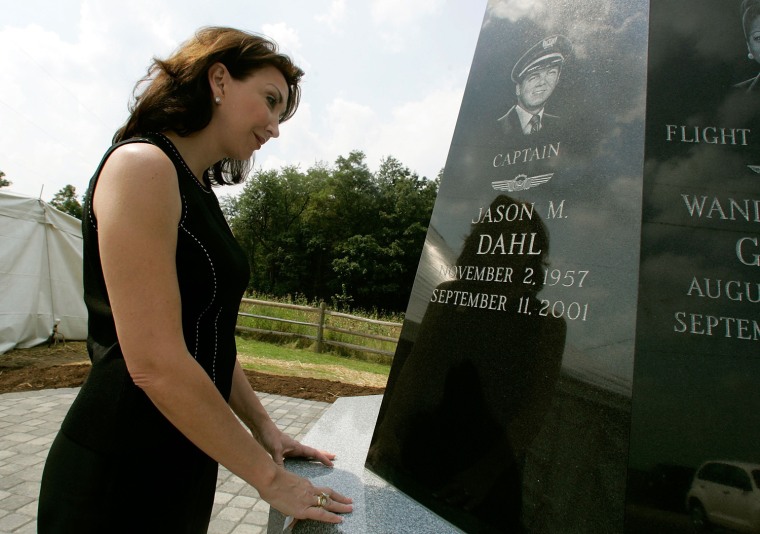 Sandy Dahl looks at the image of her husband, Pilot Jason Dahl, etched on a memorial for Flight 93 crew members at the Shanksville Chapel for Flight 93 Sept. 10, 2006, in Shanksville, Penn.