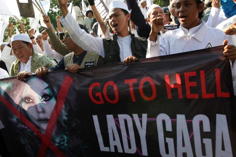 Muslim men shout slogans during a rally against U.S. pop singer Lady Gaga outside the U.S. Embassy in Jakarta, Indonesia, Friday.