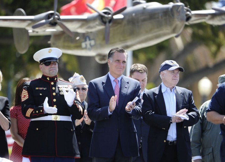 Mitt Romney, center, war veteran Nick Popaditch, left, and Sen. John McCain, R-Ariz., applaud during a Memorial Day event at the Veterans Museum & Memorial Center in San Diego on Monday.