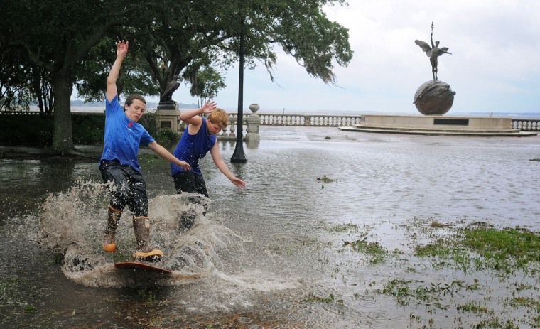 Sean Frechette and Connor Sidman skim board around Memorial Park in Riverside, Fla., in the aftermath of Tropical Storm Beryl on May 28.
