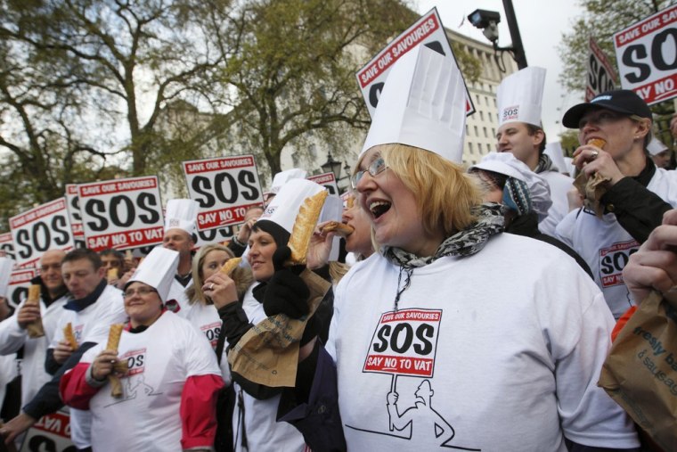 Bakers and their supporters hold pastries as they gather outside the prime minister's official residence in London in April to protest and deliver a petition against the so-called pasty tax.