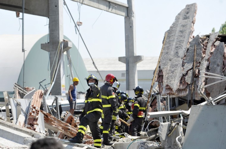 Firefighters search the debris of a collapsed factory in Mirandola, northern Italy, after magnitude 5.8 earthquake struck on May 29, 2012.