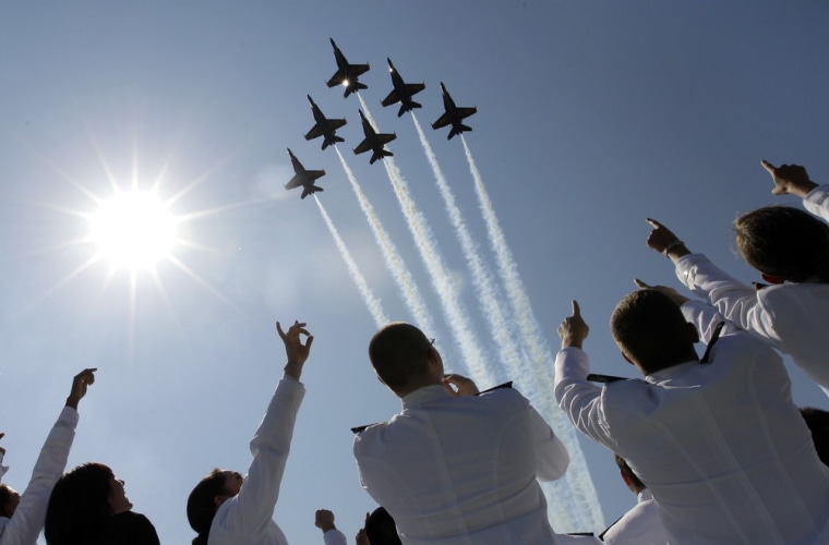 A formation of U.S. Navy Blue Angel fighter jets perform a flyover above graduating midshipmen during the United States Naval Academy graduation and commissioning ceremonies in Annapolis, Md., on Tuesday.