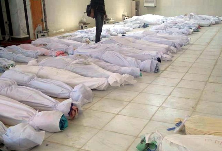 Houla Media Center, a Syrian citizen journalist group, provided this image of image of bodies covered in white shrouds following the massacre in Houla, Syria. Syrian authorities deny responsibility.
