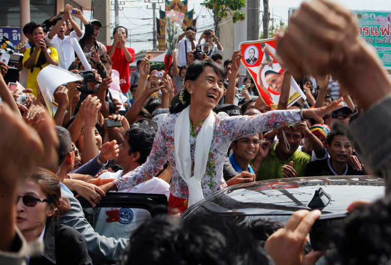 Myanmar's pro-democracy leader Aung San Suu Kyi greets migrant workers from Myanmar, as she visits them in Samut Sakhon province in Thailand on Wednesday.