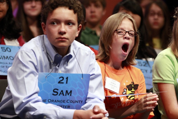 Alex Howe, 9, of Victorville, Calif,, right, yawns next to Sam T.E. Nitz, 13, of Costa Mesa, Calif., as they compete in the National Spelling Bee, Wednesday, May 30, in Oxon Hill, Md.
