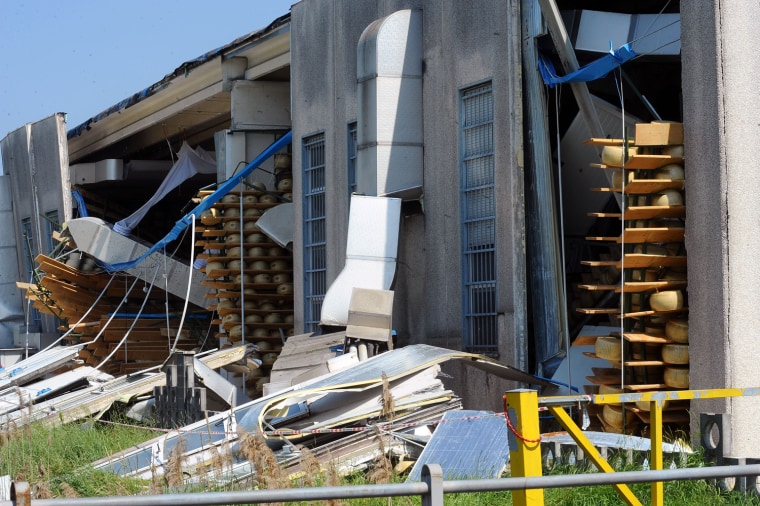 Thousands of mature Grana Padano cheeses are exposed and damaged at Latteria Sociale Tullia Pavesi factory on May 30, in Rolo, Italy.