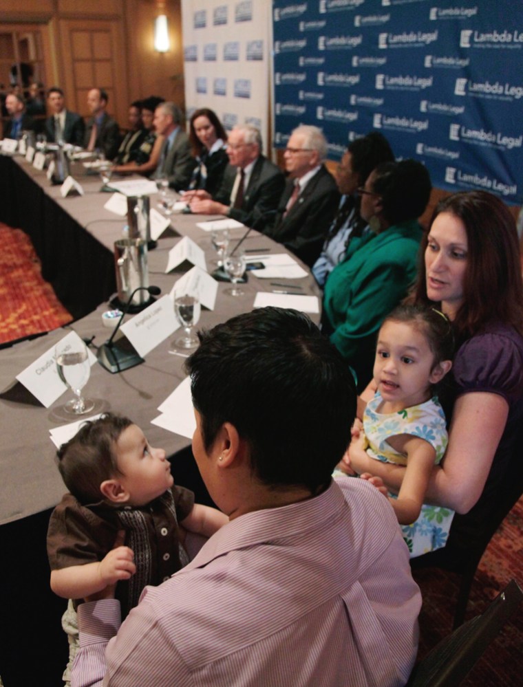 Claudia Mercado, left, holds her son Indigo Lopez-Mercado as Angelica Lopez right, holds the couple's other child, Isabel, as they gather for a news conference on the lawsuits in Chicago on May 30, 2012.