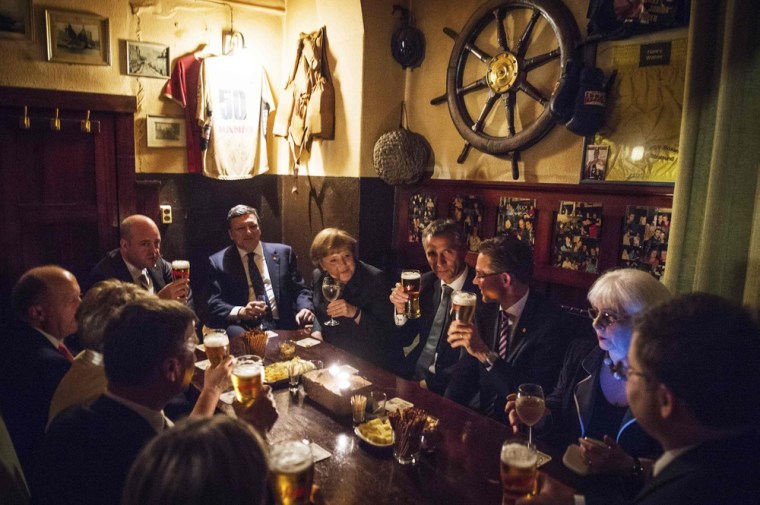 Merkel, Barroso and other leaders visit one of the oldest harbor pubs in Europe after a dinner at the start of their summit in Stralsund, May 30, 2012.