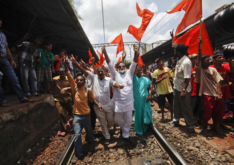 Demonstrators shout slogans while blocking railway tracks during a protest against the hike in petrol prices in Mumbai, India on May 31, 2012. A nationwide strike forced businesses, public transport, government offices and colleges to shut down in most of India's 28 states.
