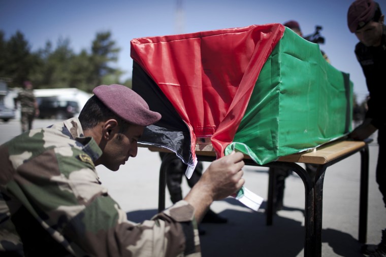A Palestinian flag is draped over one of the coffins as Israel returns the corpses of 91 militants, in the Police camp on May 31, in Ramallah, West Bank. The militants, killed during anti-Israeli attacks, were returned despite objections raised by Almagor, a group representing Israeli victims of Palestinian attack. According to officials, some of the militants were killed over 40 years ago. Twelve of the bodies were returned to Gaza.