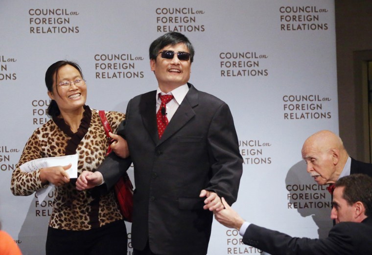Chinese activist Chen Guancheng, center, arrives with his wife Yuan Weijing, second left, before speaking at the Council on Foreign Relations on Thursday in New York City. This was Chen's first major public engagement since he escaped confinement and left China nearly two weeks ago.