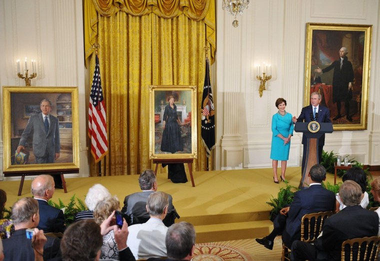 Former US president George W. Bush and his wife Laura Bush speak during the unveiling of their portraits on Thursday in the East Room of the White House in Washington, DC.