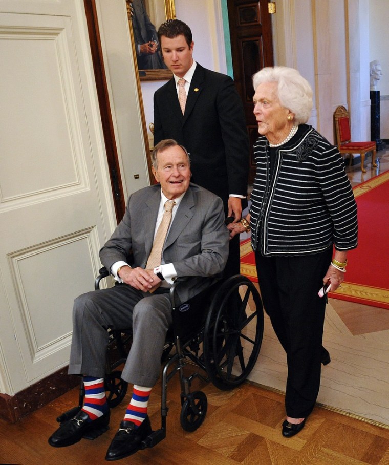 Former US President George H.W. Bush and his wife Barbara arrive for the portrait unveiling of former US president George W. Bush and his wife Laura Bush in the East Room of the White House in Washington, DC.