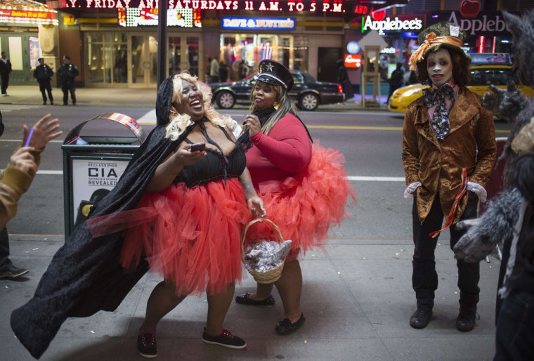 Revellers dressed up for Halloween share a laugh in Times Square, New York in the early hours of November 1, 2012.