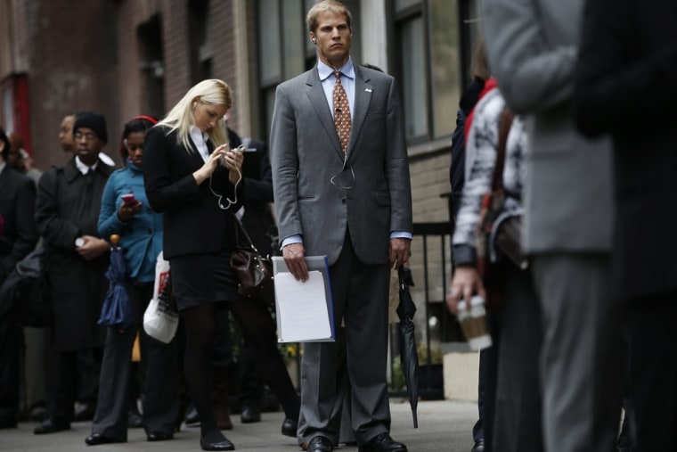 Job seekers stand in line to meet with prospective employers at a career fair in New York City, October 24, 2012.