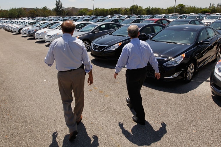 Image: Car salesman helps a customer