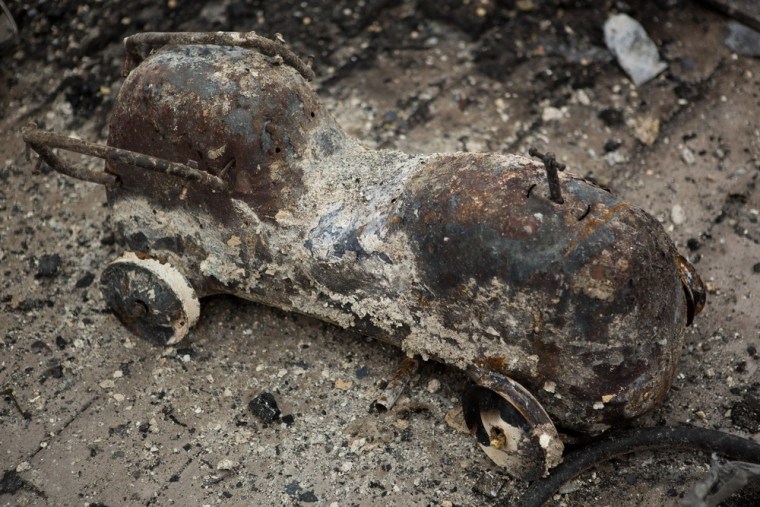 Kieran Burke's son's ride-on toy fire truck sits among the ashes of his Breezy Point home.