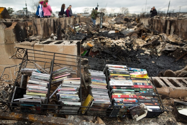 A collection of movies and music lies on the ground in Breezy Point.