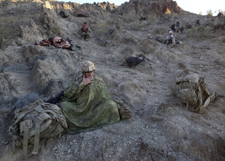 U.S. and Afghan soldiers rest during a operation on a cold morning near the town of Walli Was in Paktika province, Afghanistan on November 2, 2012.
