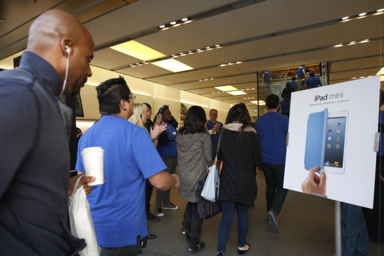 People enter an Apple Store as the doors open for the launch of the iPad mini and iPad with Retina display Wi-Fi models in Los Angeles, California, No...