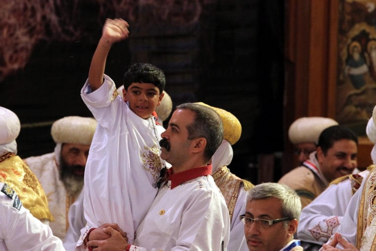 Bishoy Gerges waves to the audience after he picked out the name of Bishop Tawadros from a glass urn on Nov. 4, 2012.